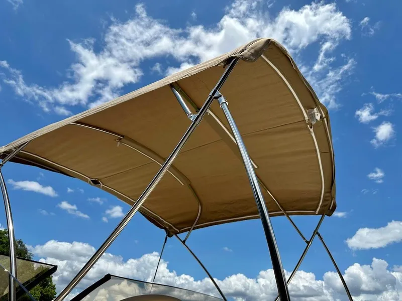 Slide: The Image of 2023 Scout 215 Dorado boat canopy against a blue sky with clouds. - 19