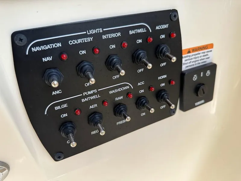 Slide: The Image of Control panel of 2023 Scout 215 Dorado boat with various switches and indicators. - 33