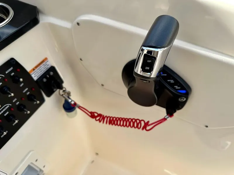 Slide: The Image of Control panel of 2023 Scout 215 Dorado boat with throttle and safety lanyard. - 36