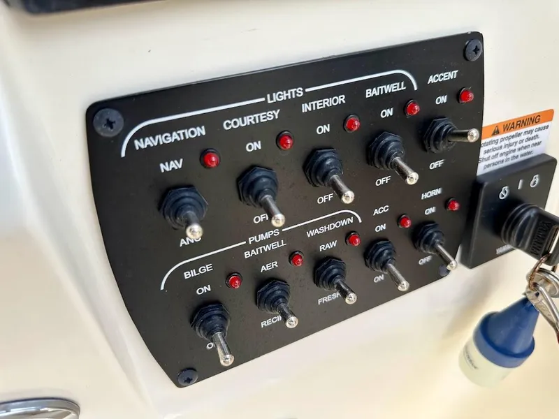 Slide: The Image of Control panel of 2023 Scout 215 Dorado boat with labeled switches and indicators. - 37