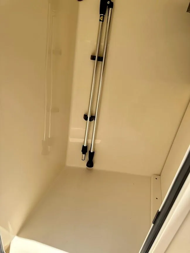 Slide: The Image of Storage compartment inside 2023 Scout 215 Dorado boat, featuring mounted rods. - 40