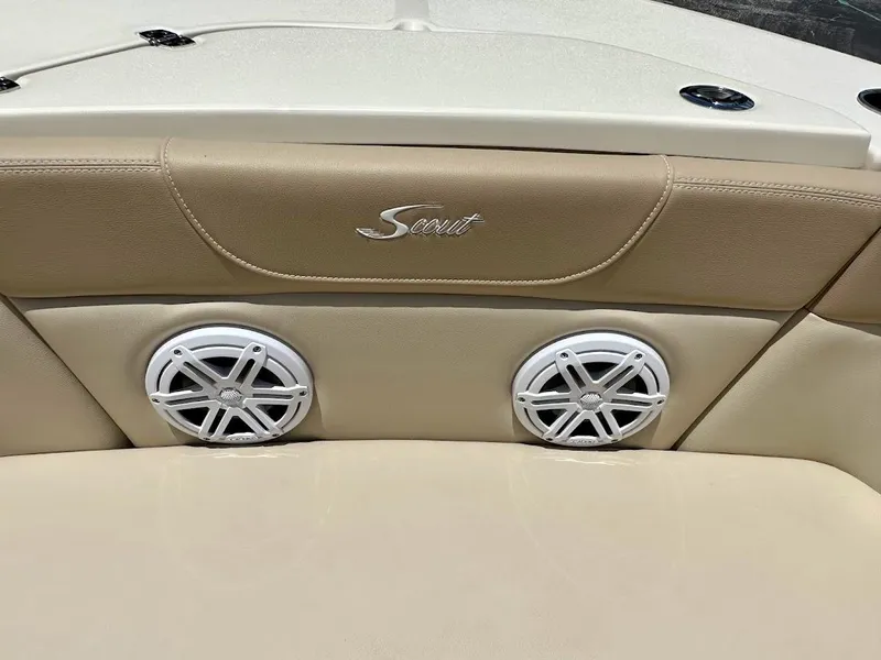 Slide: The Image of 2023 Scout 215 Dorado boat interior with speakers and logo detail. - 44