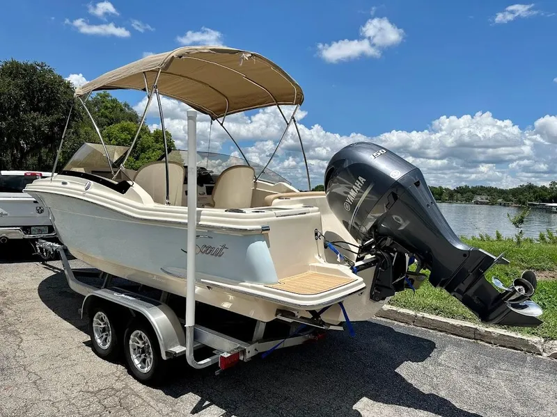 Slide: The Image of 2023 Scout 215 Dorado boat on trailer with Yamaha outboard motor, parked by a lake. - 5
