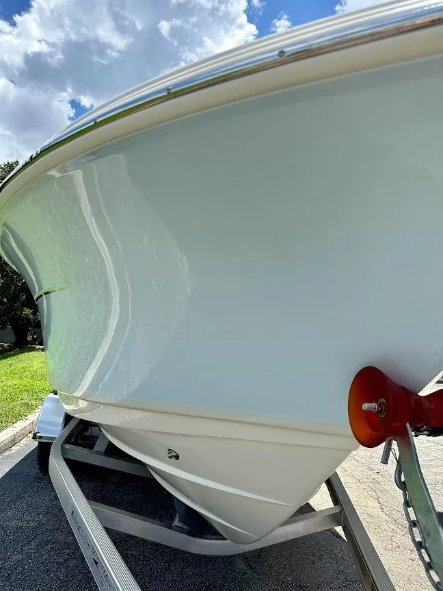 Slide: The Image of 2023 Scout 215 Dorado boat on trailer under blue sky. - 9