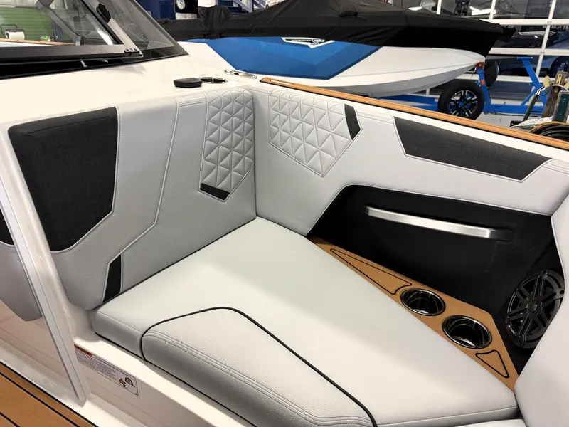 Slide: The Image of 2025 Nautique Super Air Nautique GS20 interior with stylish seating and cup holders. - 13