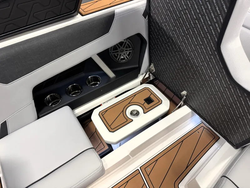 Slide: The Image of 2025 Nautique Super Air Nautique GS20 interior with cup holders and storage compartment. - 16