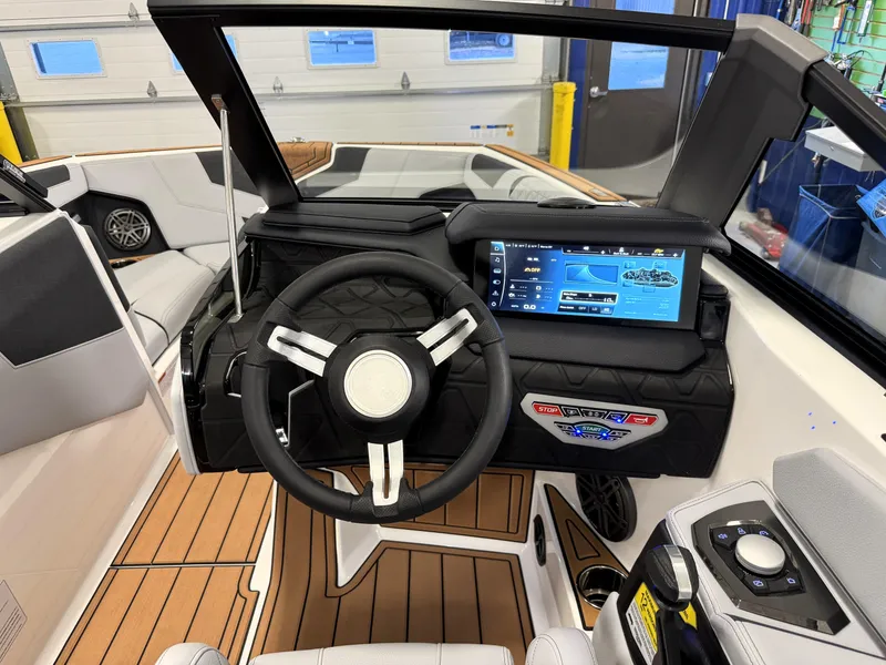 Slide: The Image of 2025 Nautique Super Air Nautique GS20 dashboard with modern steering and touchscreen display. - 7