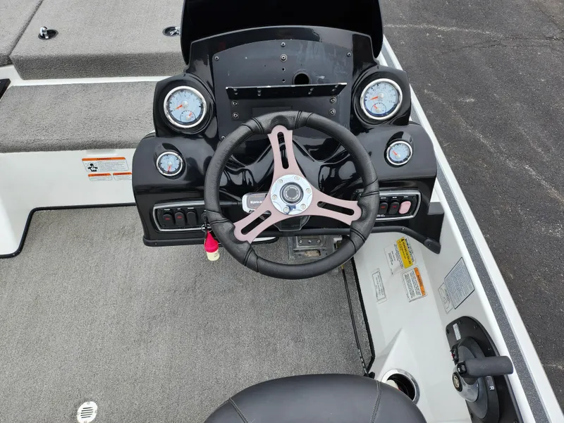 Slide: The Image of 2016 Nitro Z18 boat dashboard with steering wheel and gauges. - 12