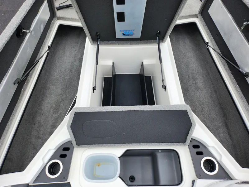 Slide: The Image of 2016 Nitro Z18 boat storage compartments and seating area, featuring organized layout and cup holders. - 15