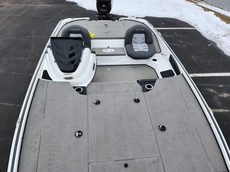 Slide: The Image of 2016 Nitro Z18 boat with dual seats and spacious deck in a snowy parking lot. - 19