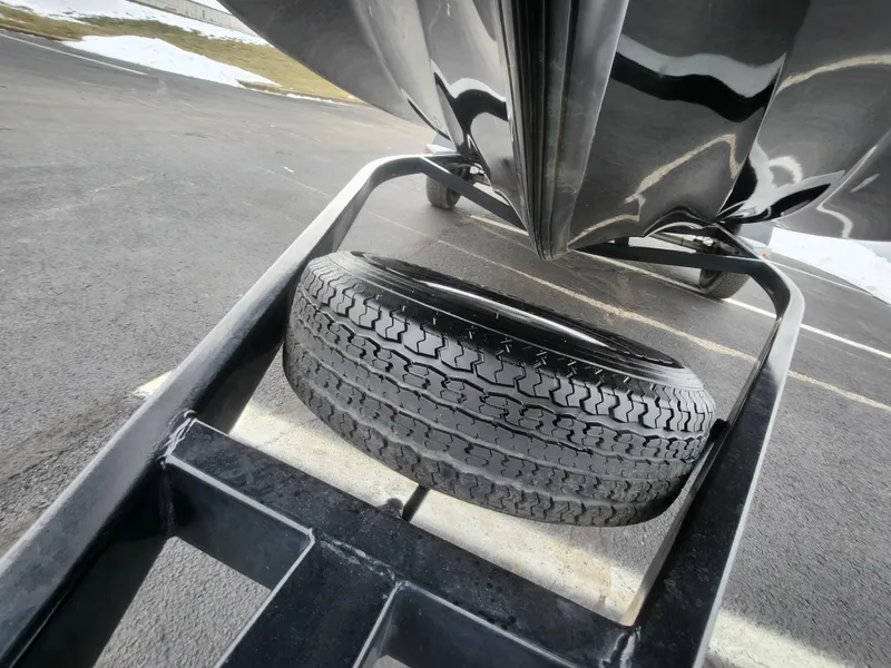Slide: The Image of Trailer tire under a 2016 Nitro Z18 boat on a paved surface. - 8