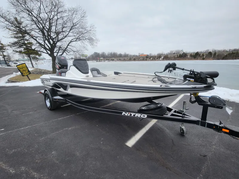 Slide: The Image of 2016 Nitro Z18 boat on trailer by a lake in winter setting. - 9