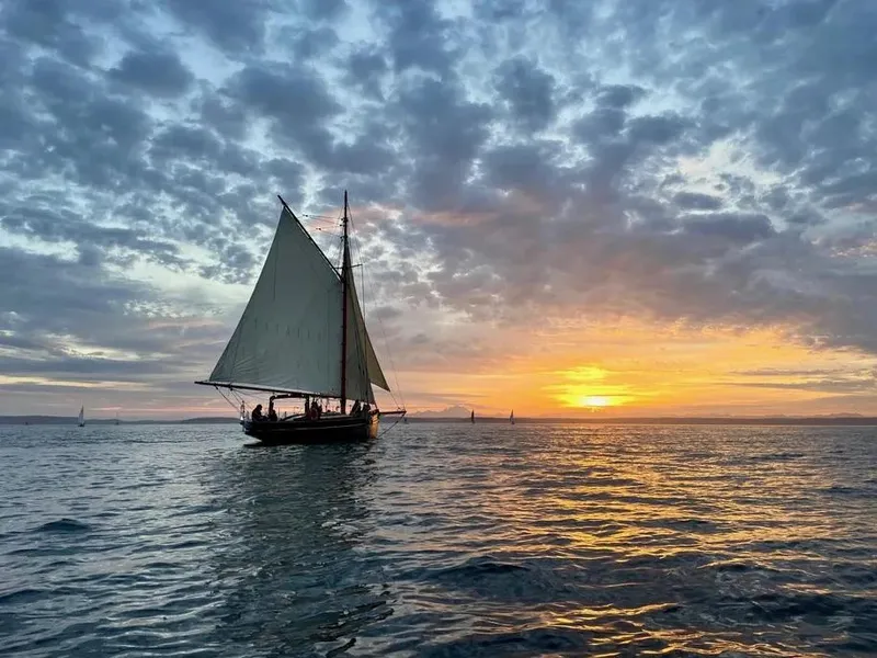 Slide: The Image of Sailing boat "Morecambe Bay Prawner 38'" at sunset, 1903 model, on calm sea. - 12