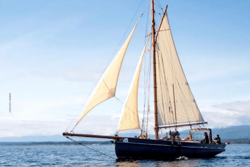 Slide: The Image of Vintage 1903 Morecambe Bay Prawner 38' sailing on open water under clear skies. - 2