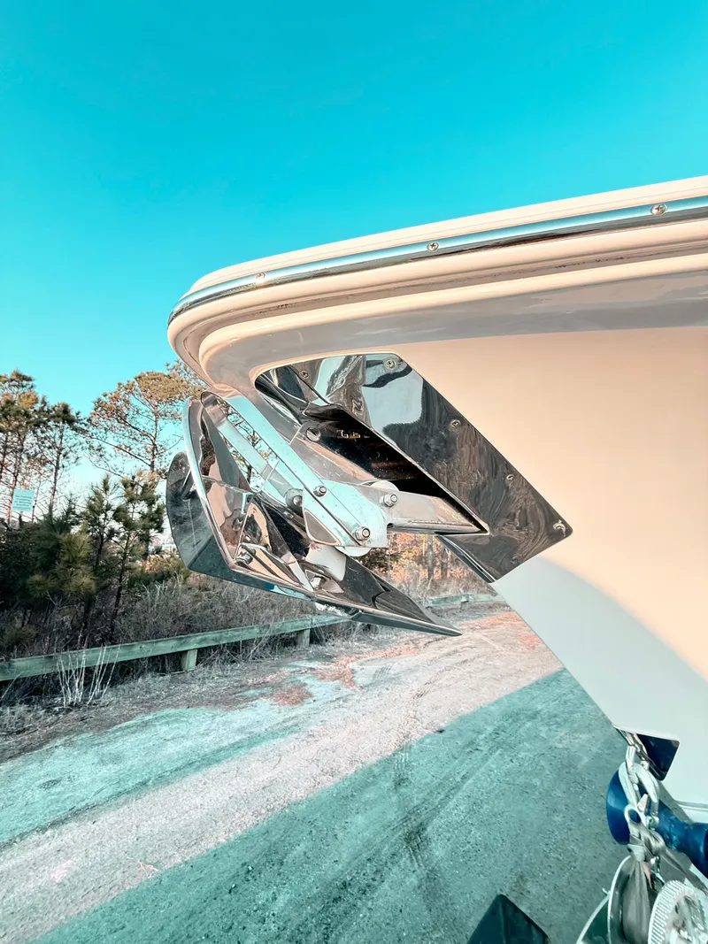 Slide: The Image of 2023 Sea Hunt Ultra 305 SE boat with stainless steel anchor, clear sky background. - 17