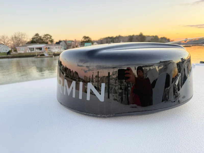 Slide: The Image of Garmin radar on 2023 Sea Hunt Ultra 305 SE boat at sunset by the water. - 18