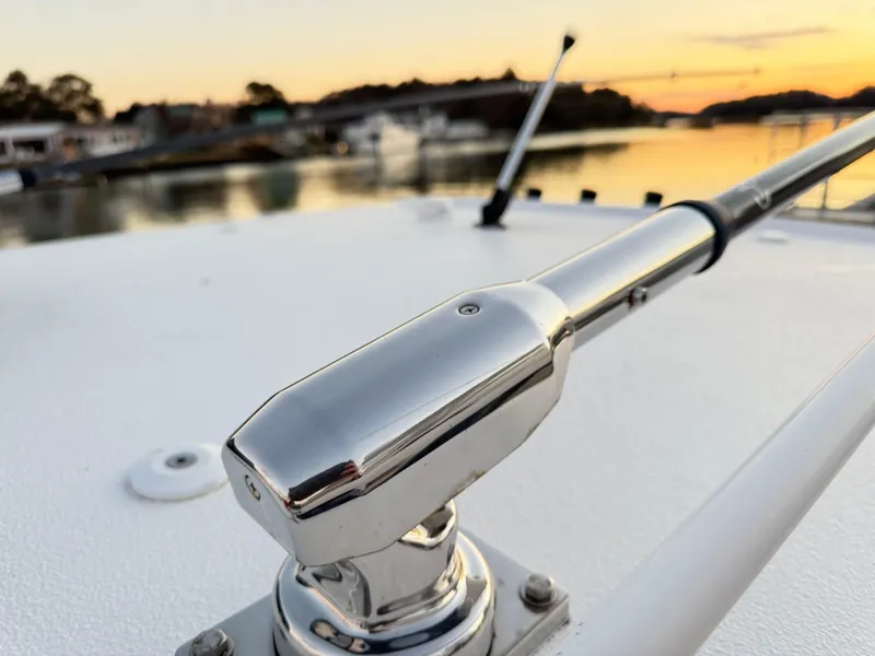 Slide: The Image of Close-up of 2023 Sea Hunt Ultra 305 SE boat railing at sunset. - 19