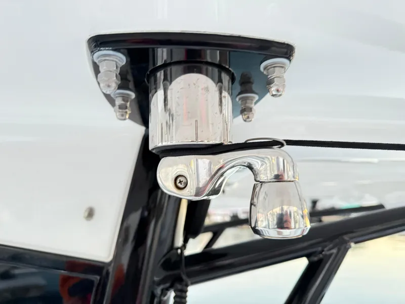 Slide: The Image of Close-up of a 2023 Sea Hunt Ultra 305 SE boat component, featuring a metallic fixture. - 20