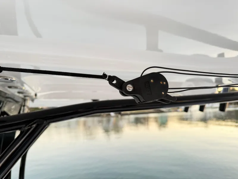 Slide: The Image of Close-up of a 2023 Sea Hunt Ultra 305 SE boat component against a calm water backdrop. - 21