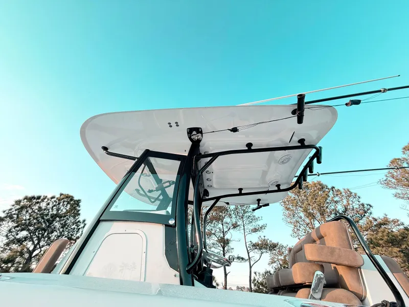 Slide: The Image of 2023 Sea Hunt Ultra 305 SE boat with T-top against clear sky. - 24