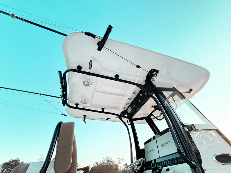 Slide: The Image of 2023 Sea Hunt Ultra 305 SE boat with T-top and fishing rod holders. - 25