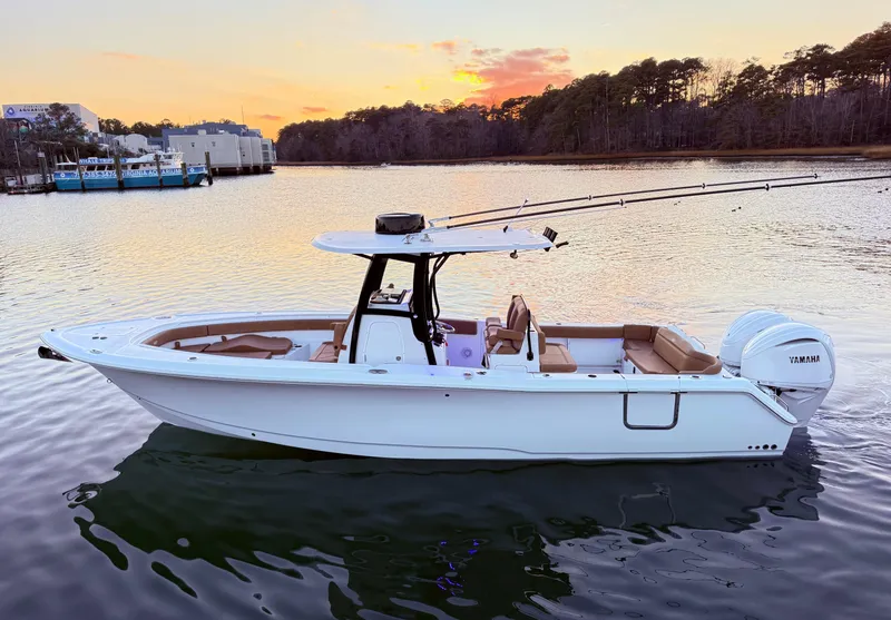 Slide: The Image of 2023 Sea Hunt Ultra 305 SE boat on calm water at sunset. - 27