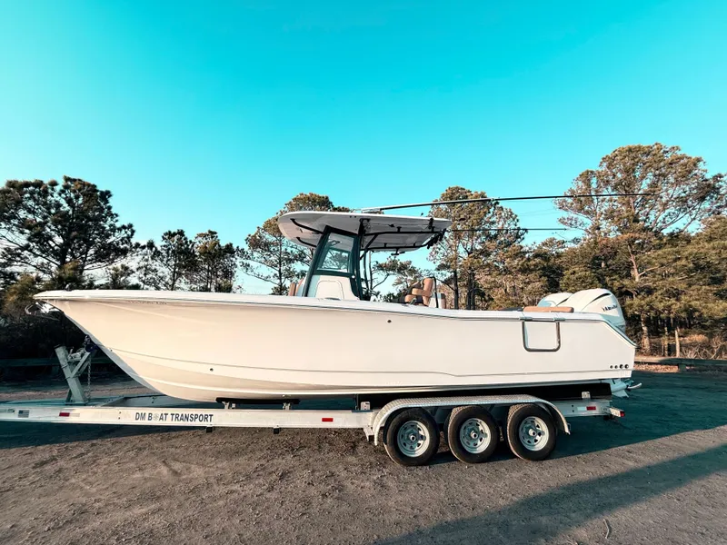 Slide: The Image of 2023 Sea Hunt Ultra 305 SE boat on trailer, parked outdoors. - 30