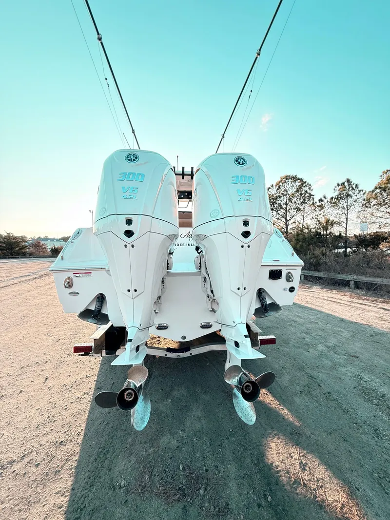 Slide: The Image of 2023 Sea Hunt Ultra 305 SE boat with dual outboard engines, rear view. - 36