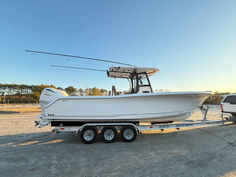 Slide: The Image of 2023 Sea Hunt Ultra 305 SE boat on trailer, parked outdoors. - 37