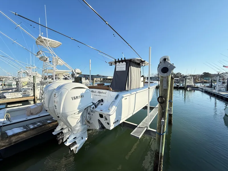 Slide: The Image of 2023 Sea Hunt Ultra 305 SE boat docked with dual Yamaha engines. - 39