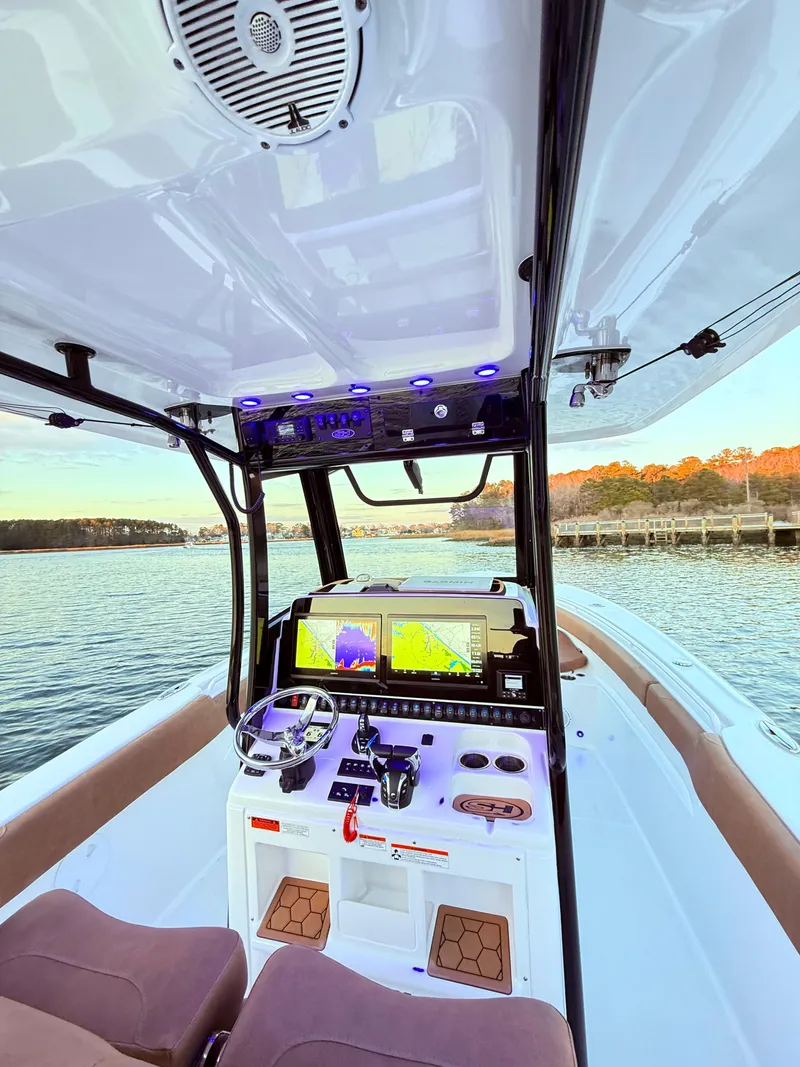 Slide: The Image of 2023 Sea Hunt Ultra 305 SE boat interior with advanced navigation system and comfortable seating. - 4