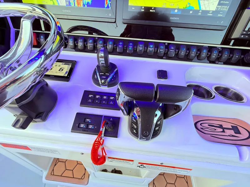 Slide: The Image of 2023 Sea Hunt Ultra 305 SE boat dashboard with controls and navigation screens. - 6