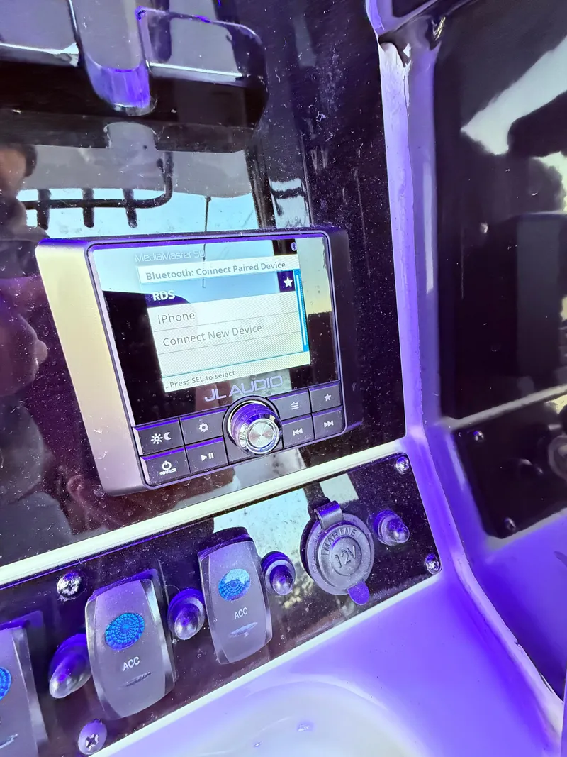 Slide: The Image of Control panel of 2023 Sea Hunt Ultra 305 SE boat with Bluetooth connectivity. - 7