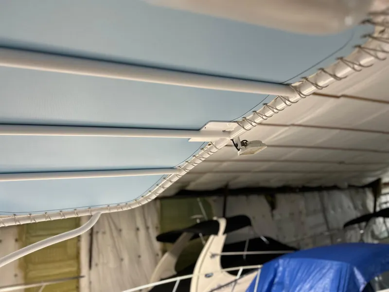 Slide: The Image of 2007 Donzi 38 ZF Cuddy boat interior with blue canopy and metal framework. - 17