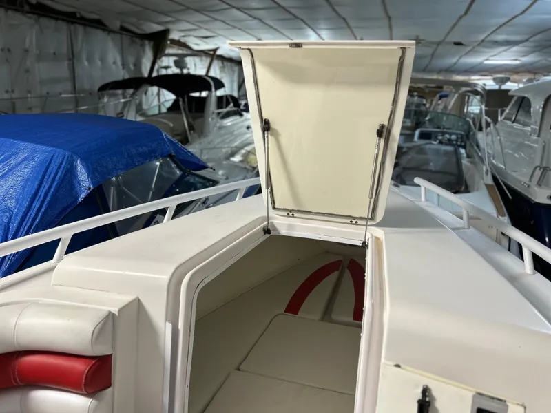 Slide: The Image of 2007 Donzi 38 ZF Cuddy boat interior with open hatch in storage facility. - 2