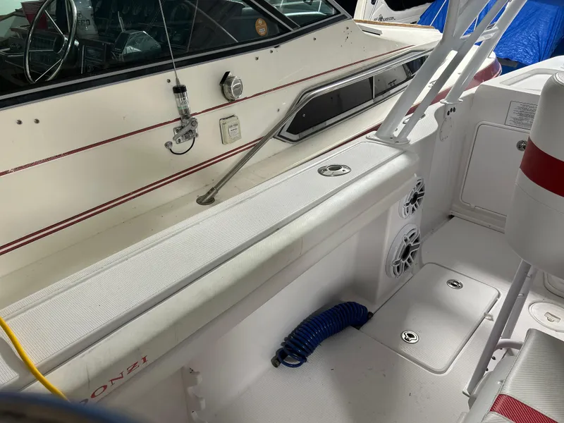 Slide: The Image of 2007 Donzi 38 ZF Cuddy boat interior with seating, storage, and marine equipment. - 4