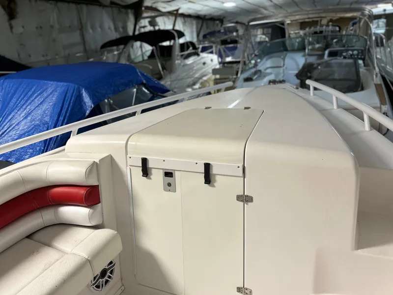 Slide: The Image of 2007 Donzi 38 ZF Cuddy boat interior in storage, featuring white and red seating. - 7