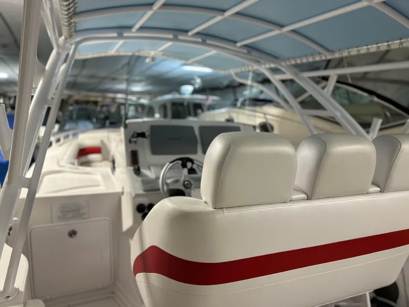 Slide: The Image of 2007 Donzi 38 ZF Cuddy boat interior with white and red seating, under a canopy. - 8