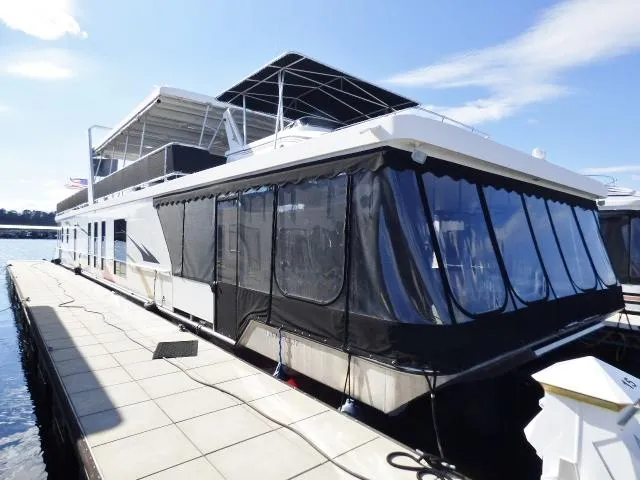 The Image of 2006 Thoroughbred 20x90 houseboat docked on a sunny day with covered deck. - 0