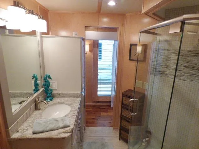 Slide: The Image of Modern bathroom in Thoroughbred 20x90, 2006 model, featuring glass shower and elegant decor. - 10