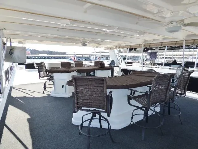 Slide: The Image of Spacious deck area on 2006 Thoroughbred 20x90 yacht with seating and tables. - 18