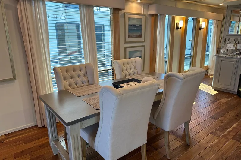 Slide: The Image of Luxurious dining area in a 2006 Thoroughbred 20x90 houseboat with elegant decor. - 6