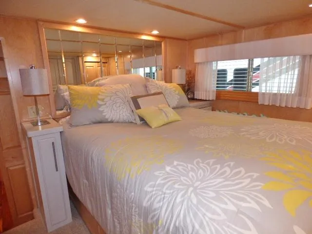 Slide: The Image of Cozy bedroom in 2006 Thoroughbred 20x90 houseboat with floral bedding and mirrored headboard. - 7