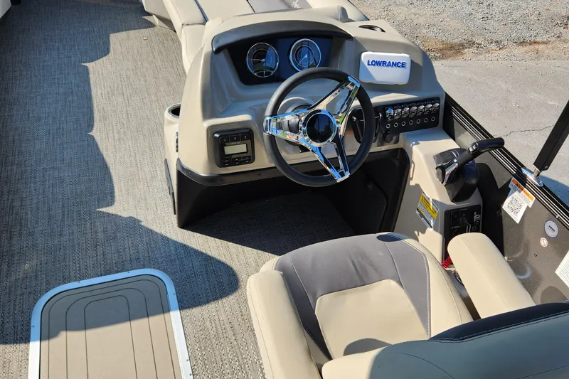Slide: The Image of 2024 Barletta Aria 24QC boat interior with steering wheel and control panel. - 5