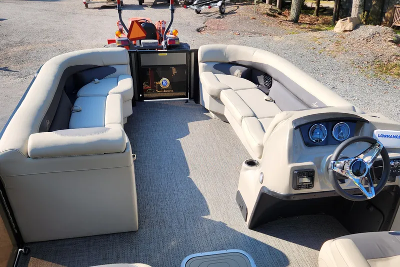Slide: The Image of 2024 Barletta Aria 24QC pontoon boat interior with plush seating and modern dashboard. - 7