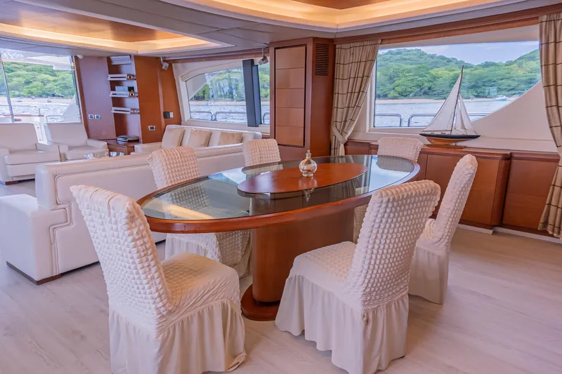 Slide: The Image of Luxurious interior of 2006 Azimut 105 Grande yacht with elegant dining area and scenic views. - 11