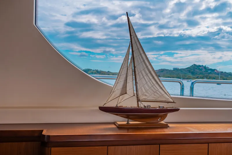 Slide: The Image of Model sailboat displayed inside 2006 Azimut 105 Grande yacht, with scenic ocean view. - 16