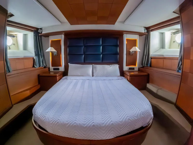 Slide: The Image of Luxurious bedroom interior of 2006 Azimut 105 Grande yacht with elegant wood paneling. - 20