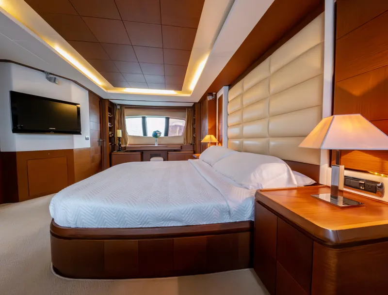 Slide: The Image of Luxurious bedroom interior on 2006 Azimut 105 Grande yacht, featuring elegant wood finishes. - 21