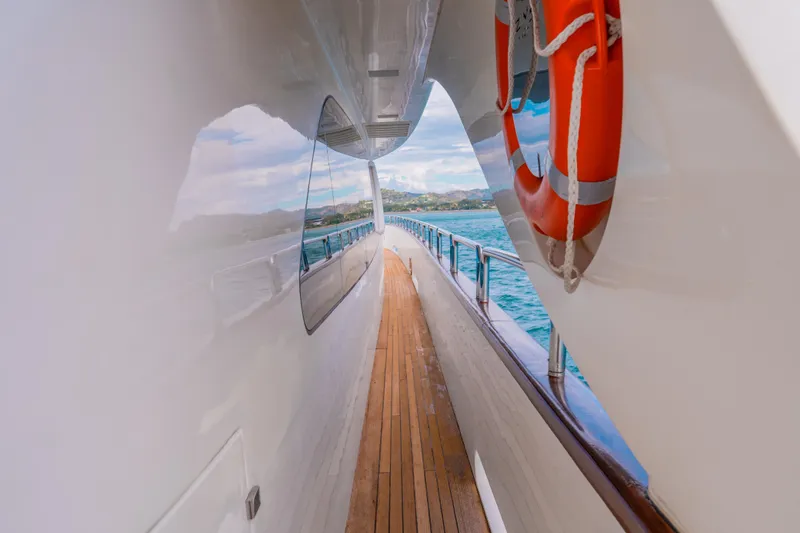 Slide: The Image of Side deck view of 2006 Azimut 105 Grande yacht with ocean backdrop. - 24